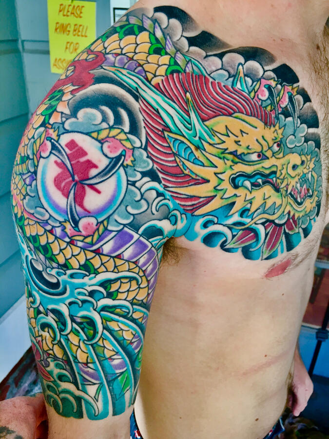 Bold colorful traditional Japanese half sleeve tattoo angle one