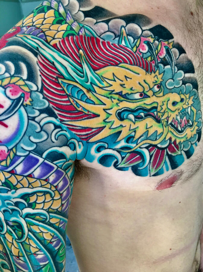 Japanese dragon half sleeve tattoo chest plate. By Ezra Bold color traditional Japanese dragon half sleeve tattoo angle two
