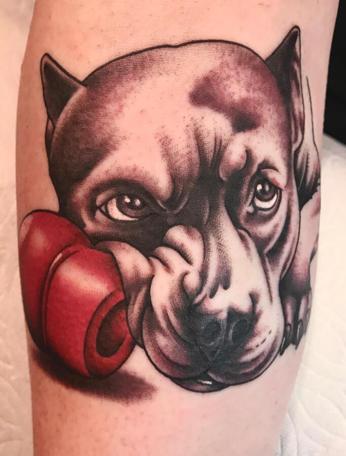 Realistic dog portrait tattoo done in black and gray